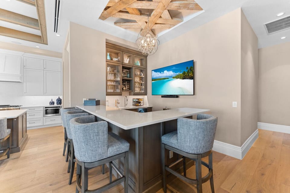 Unwind with a cocktail or catch the game from your stylish bar nook.
