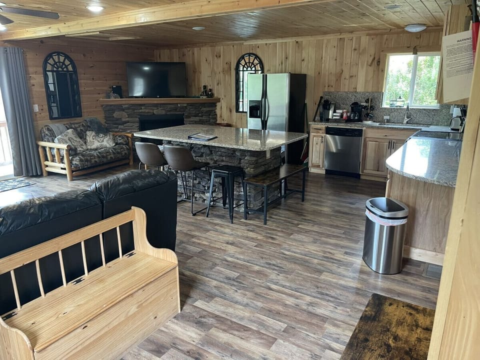Open floor plan with 55 inch Smart tv large Granite Island and fully stocked kitchen