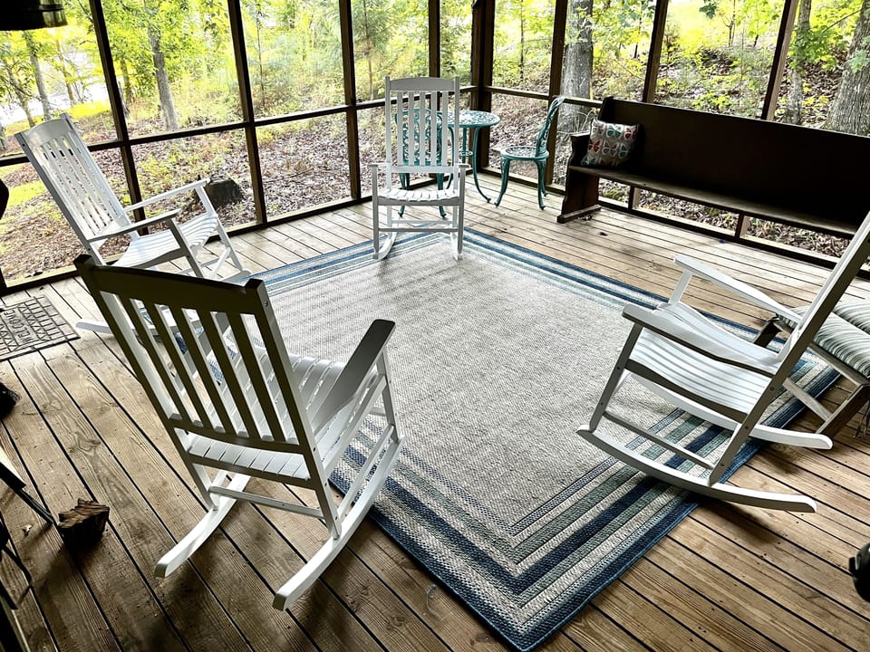 This screened porch is ideal for reading, rocking, and quiet time. 