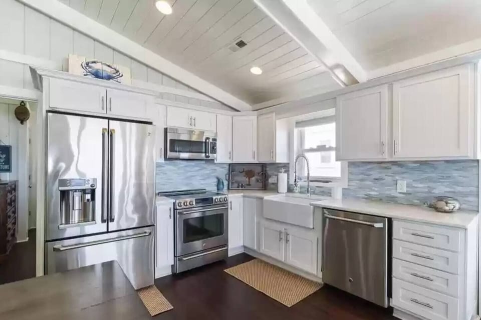 Gourmet kitchen with all the tools to make a meal from scratch or reheat a meal from a local restaurant. Refrigerator with cold/hot water dispenser, ice dispenser and Keurig coffee maker. Electric stove, oven. Microwave doubles as a convection oven