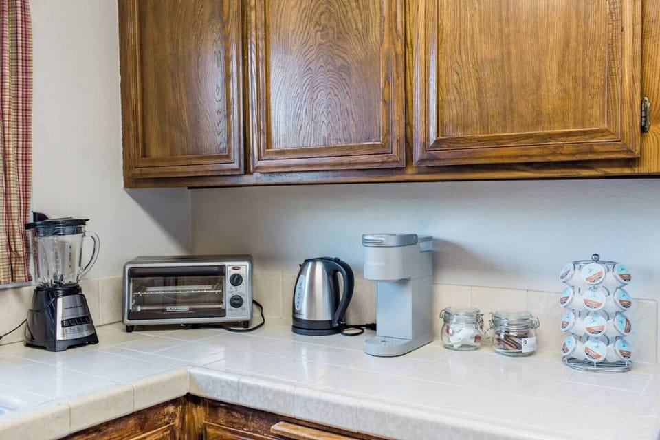 Kitchen equipped with coffee + tea goods, toaster oven, blender, etc.