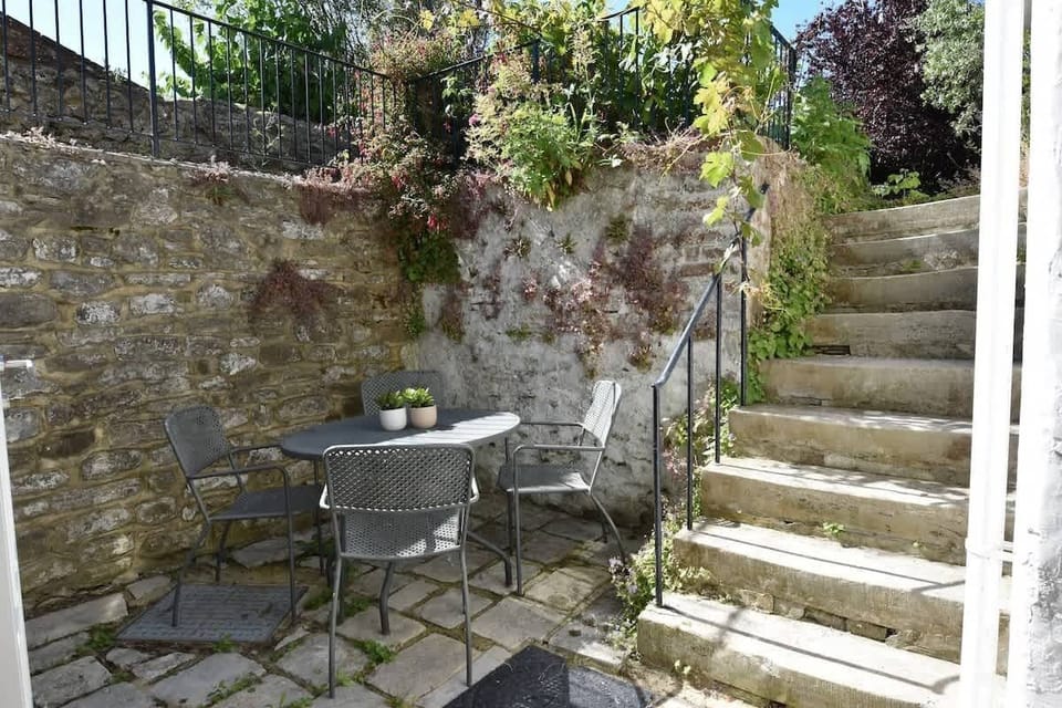 A spacious paved patio with outdoor dining, perfect for summer BBQs with your four-legged friends.