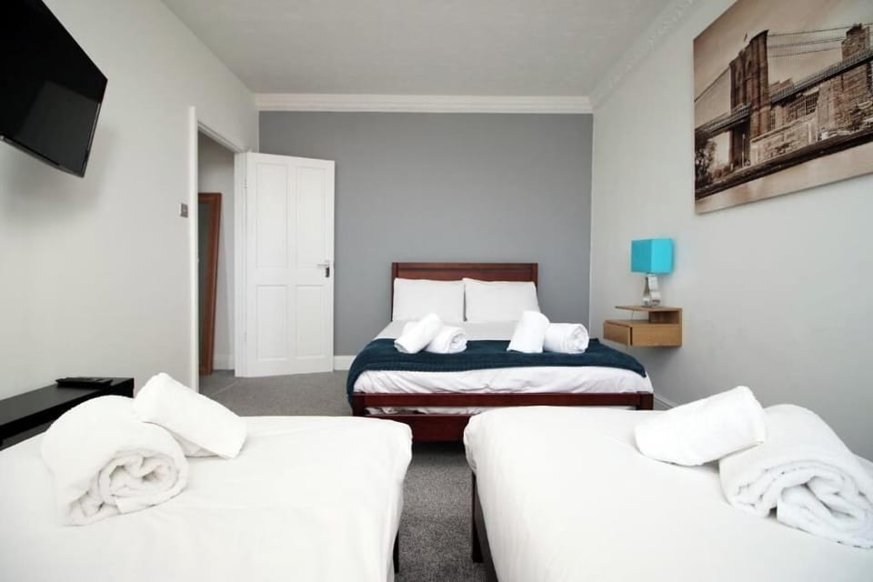 Step into our charming apartment, where comfort meets character. The bedroom is designed with a warm, cozy vibe featuring a comfortable bed with soft linens, fluffy pillows, and warm lighting that creates the perfect space to relax and unwind.