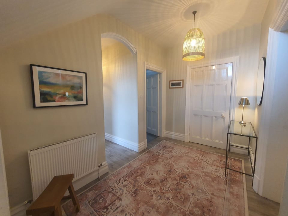 The front door opens into a spacious and elegant hallway