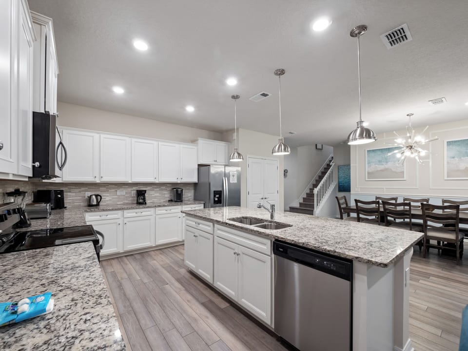 Modern Full Size Kitchen with Kitchen Essentials Including Refrigerator, Microwave, and Dishwasher