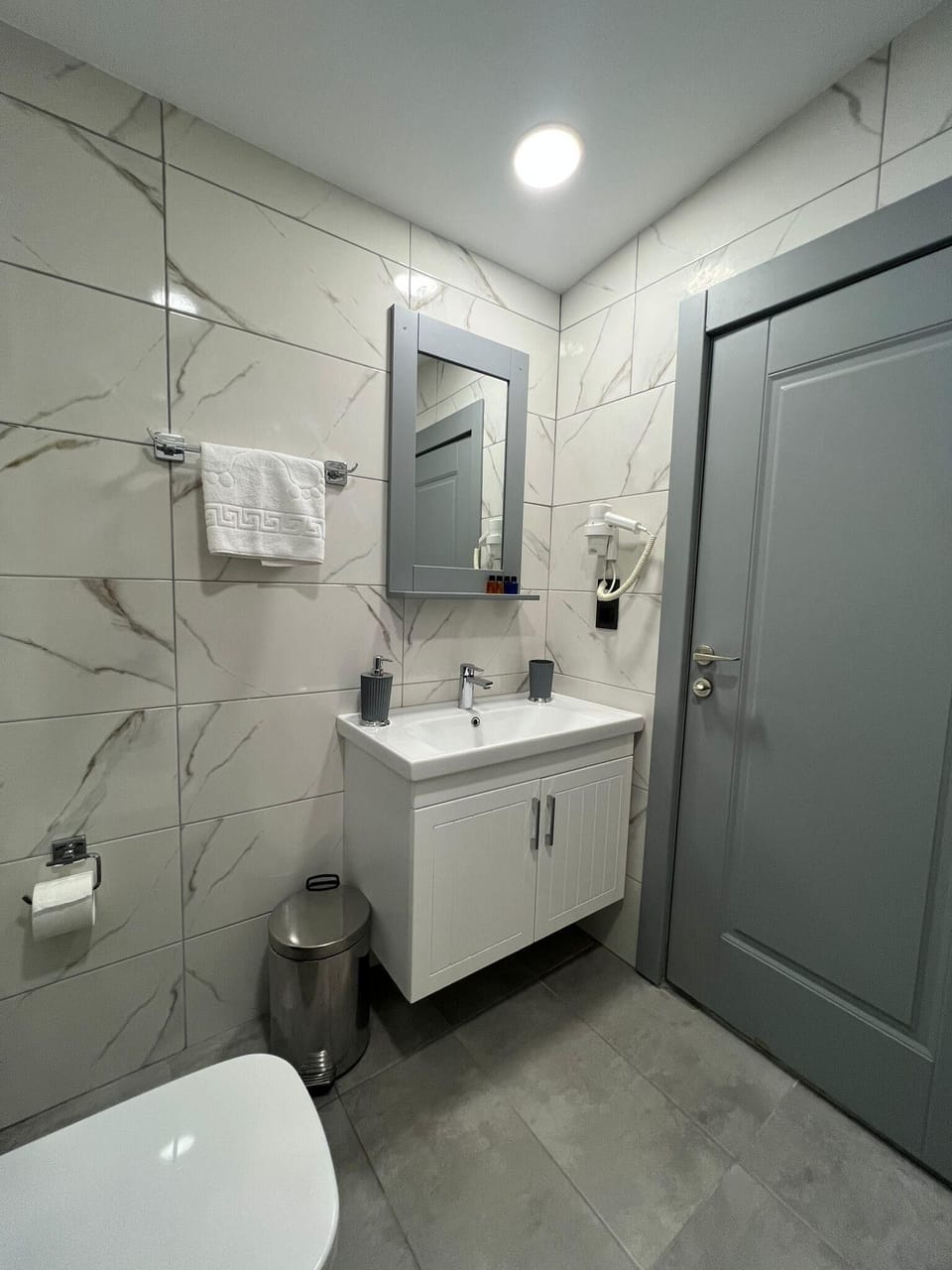 Shower, hair dryer, slippers, towels