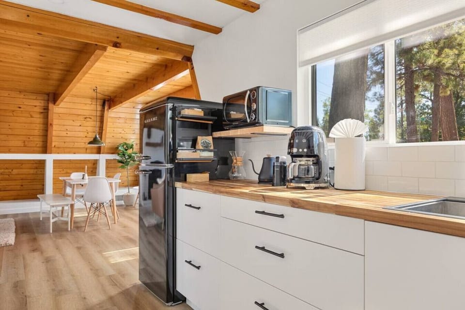 You will find high-quality cookware, dining ware and utensils in this modern and updated kitchen space.