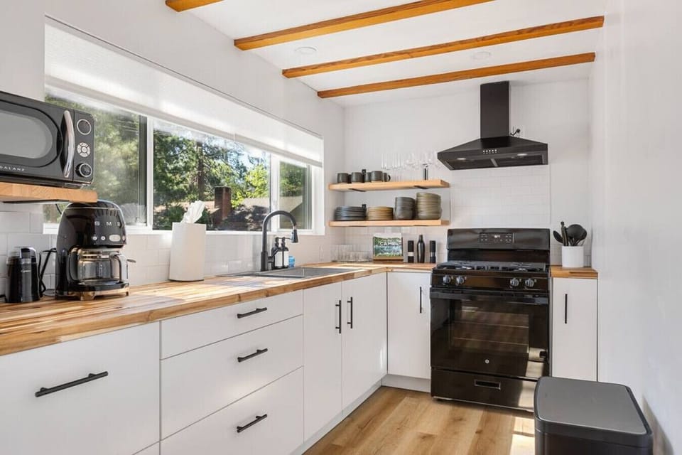 Fully stocked kitchen with a stocked coffee bar that includes sweeteners and creme.