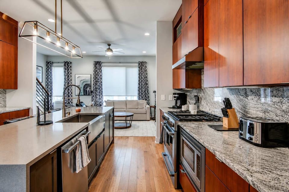 Spacious kitchen with a large island, built-in sink, and dishwasher for easy cooking, dining, and cleanup.