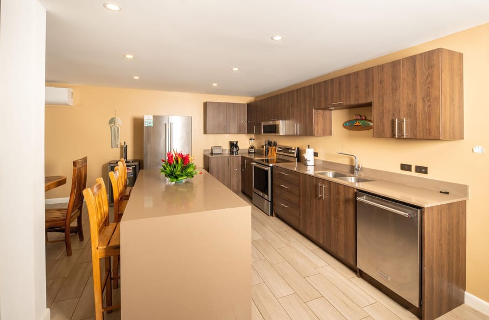 Spacious modern kitchen with sleek appliances and breakfast bar