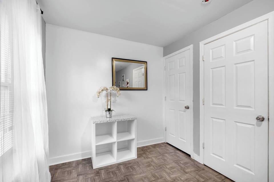 Bedroom entrance with modern white door leading to private sleeping quarters.