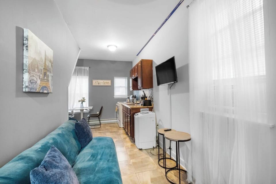 Living room entertainment area with flat-screen TV ready for streaming Netflix and Hulu.