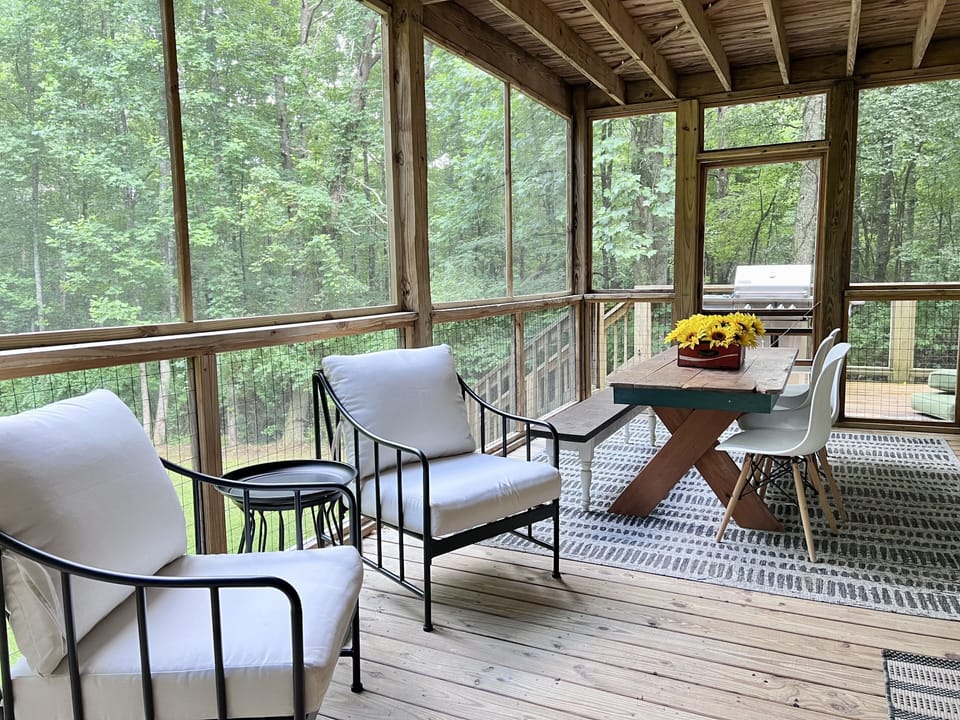 Lots of comfy seating for lounging and meals on the main level screened porch.