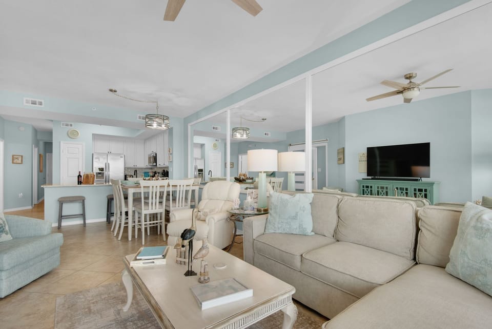 Relax in your open-concept living space with soothing coastal colors, comfortable seating, and modern amenities throughout.