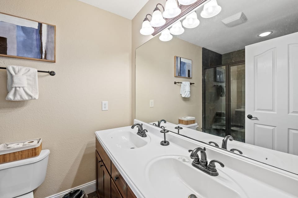 Master bathroom with large walk-in natural stone tile, matching grout, and shower seat included. Luxury shower head with multiple spray settings.