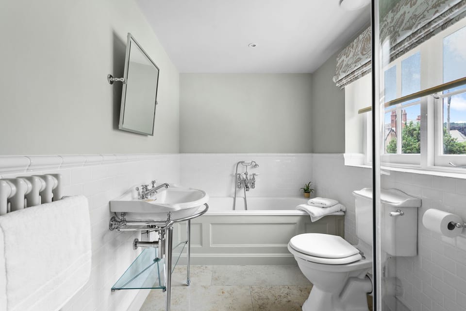 Family bathroom with bathtub and shower - Poplar Cottage