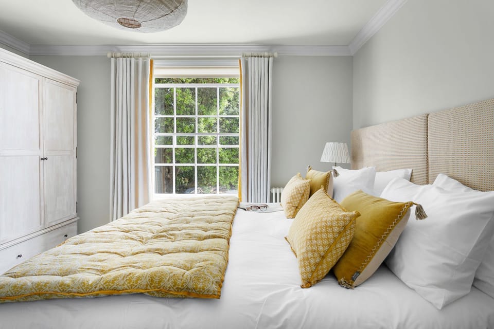 Bedroom with wardrobe and large window - Poplar Cottage