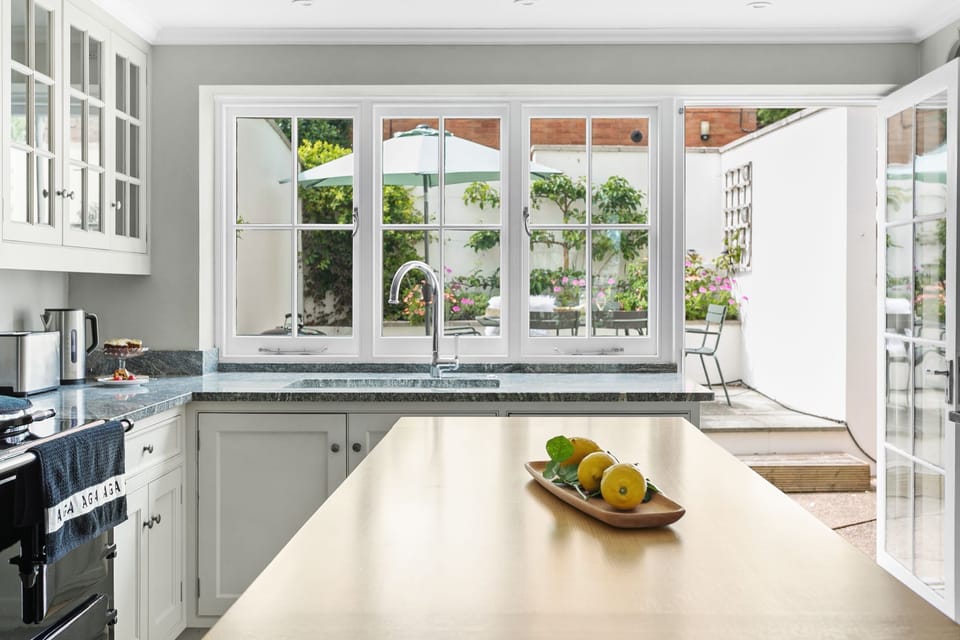 Kitchen with view into garden, breakfast bar seating for two - Poplar Cottage