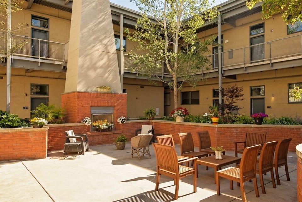 The condo complex boasts a center entertainment area with seating, a fireplace, and BBQ grills.