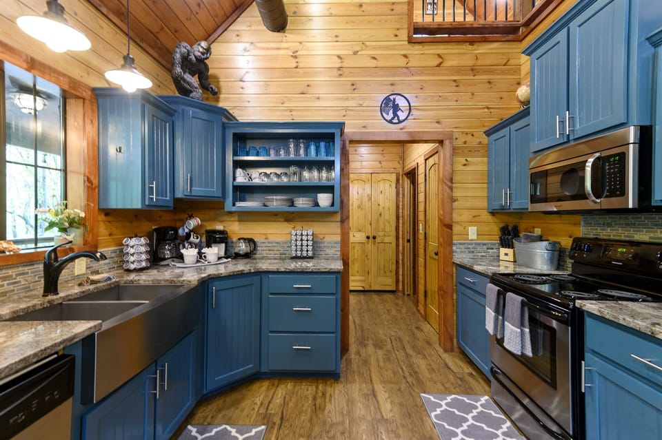 This well-appointed cabin kitchen blends rustic charm with modern comforts, creating a warm and inviting space for both cooking and gathering. Nature's beauty outside, culinary delights inside – the perfect recipe for a cozy retreat