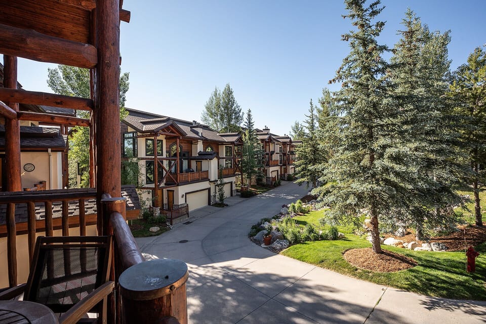Modern mountain retreat with manicured landscaping and peaceful residential setting surrounded by mature evergreens.