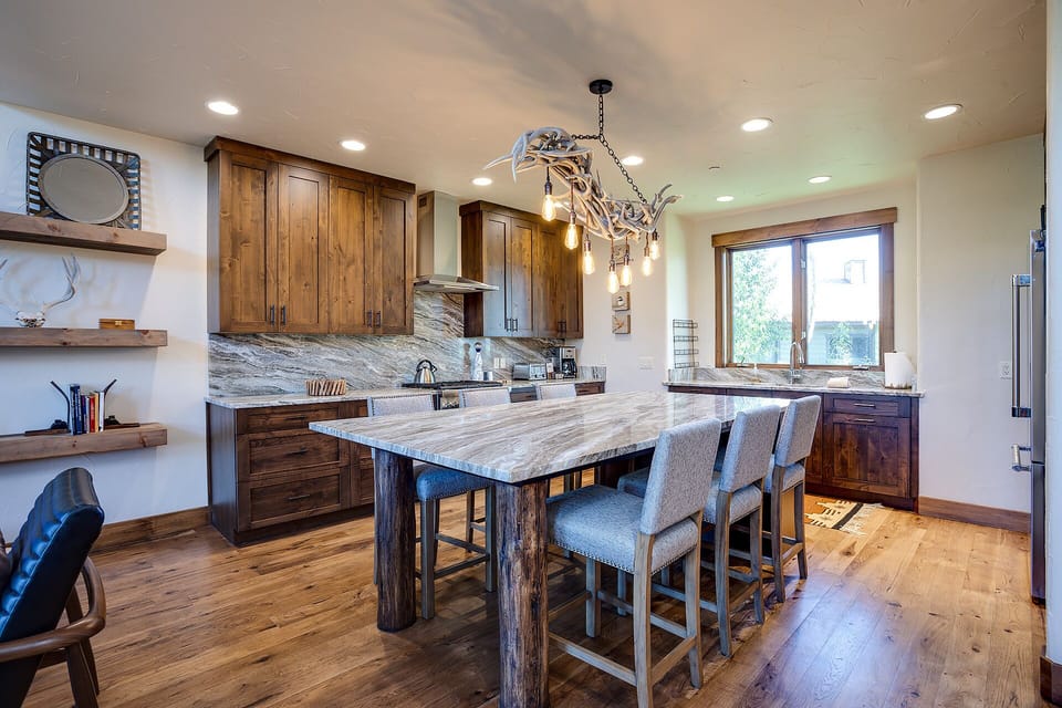 Your gourmet kitchen features rich wood cabinetry, stunning marble countertops, and a spacious island for memorable meal prep together.