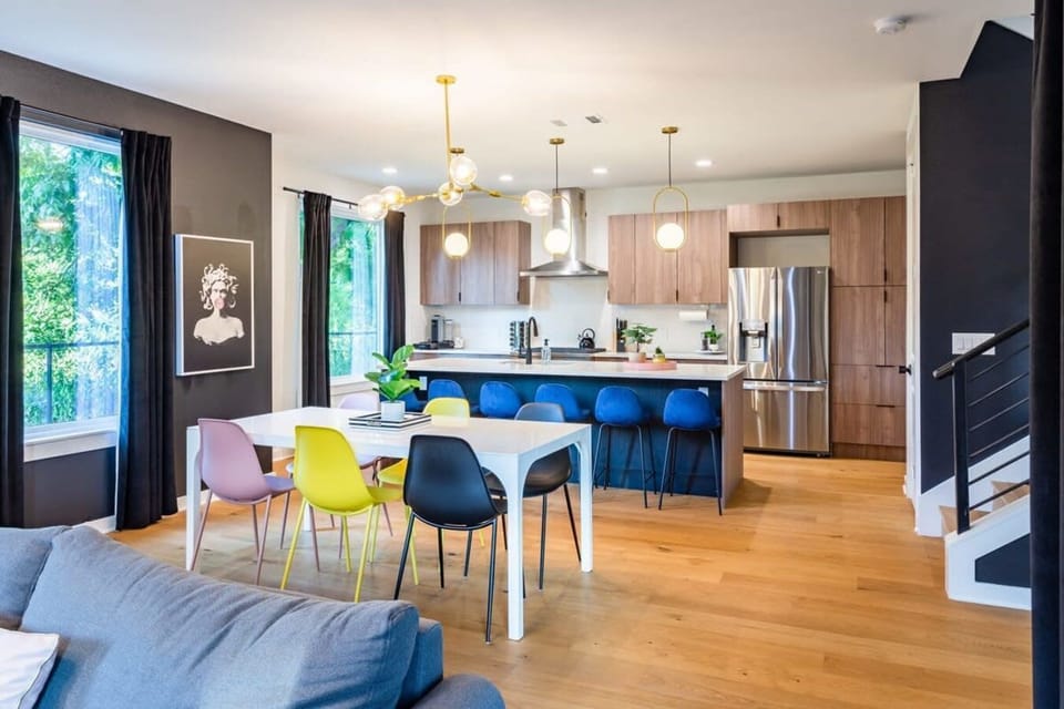 Spacious Kitchen And Dining Area With Modern Design And High Chairs By The Island