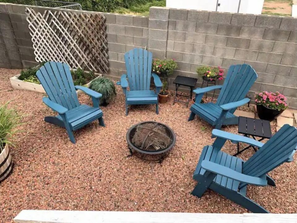 The backyard includes a fire pit area, propane barbecue grill and hammock