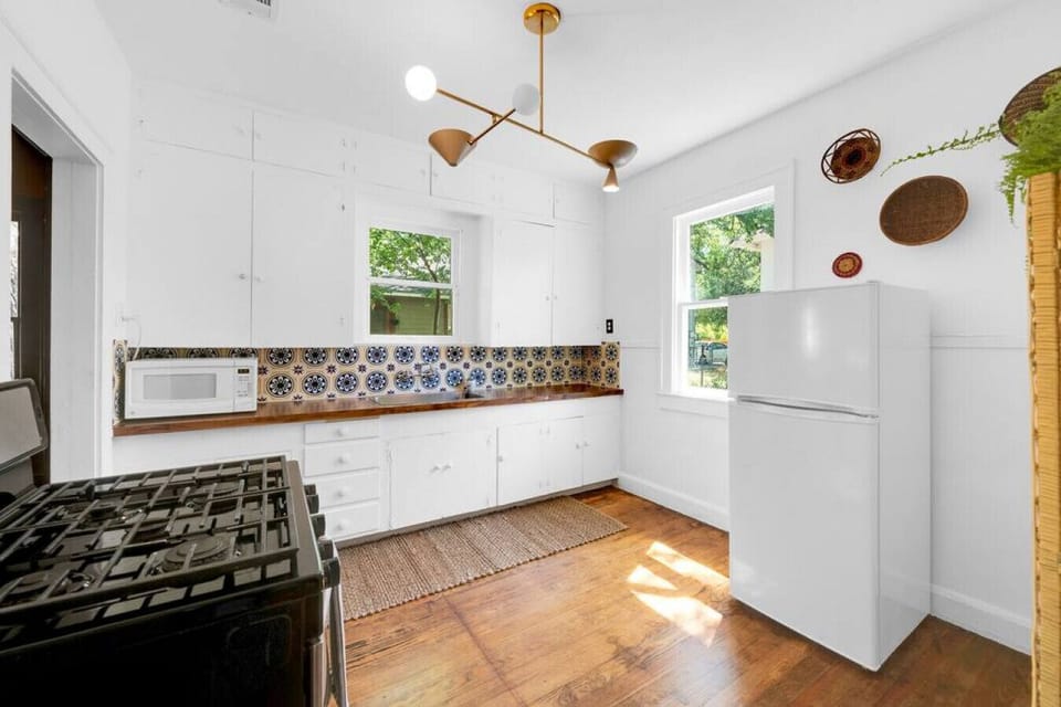 New butcher block counter tops and Moroccan tile plus funky light fixture