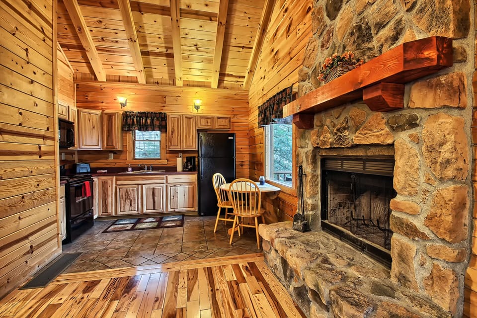 Closeup of Wood-Burning Fireplace and Full Kitchen, from Living Room