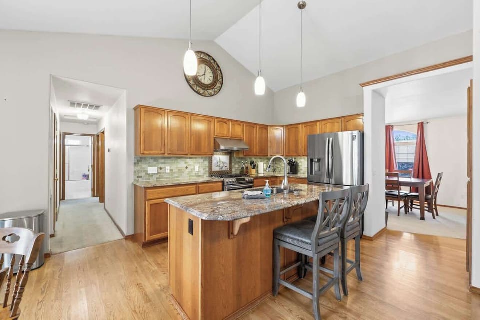 Fully equipped kitchen with a spacious island, bar seating, and modern appliances.