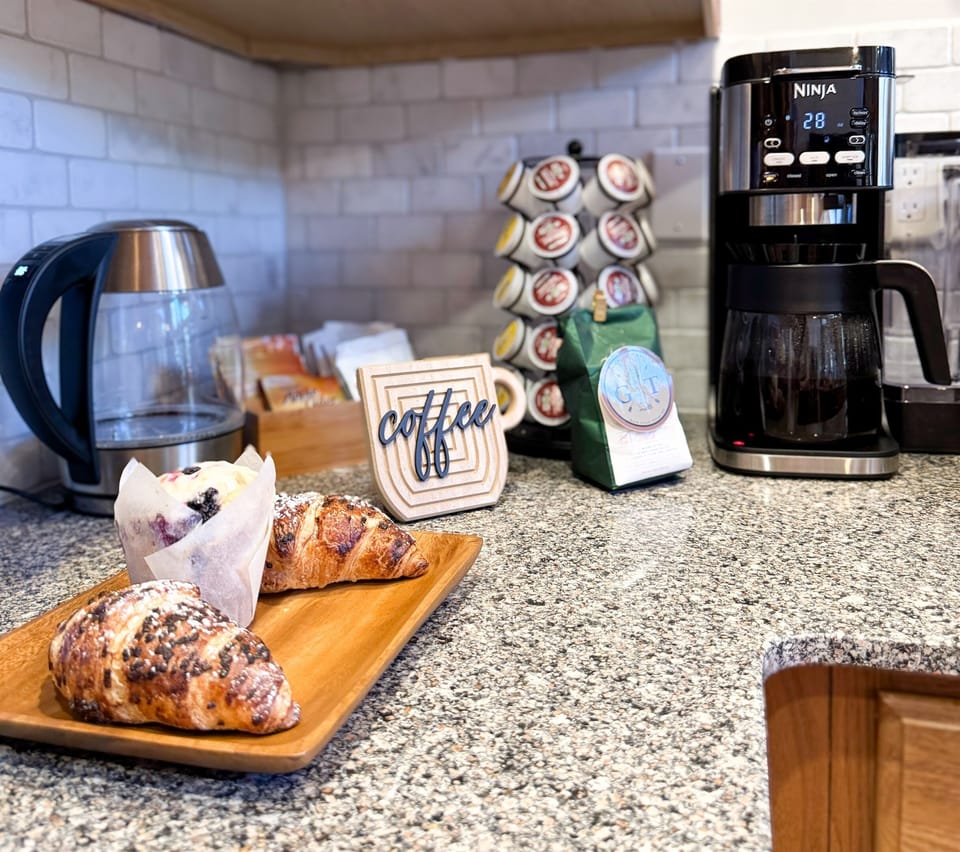 We offer complimentary hot beverages: coffee pods, teas,  hot chocolate, and hot cider. Bring your favorite coffee grounds for our drip coffee pot.
