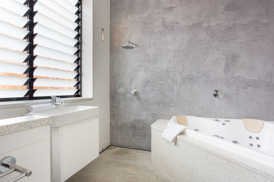 Ensuite bathroom to main bedroom with large bath and open shower