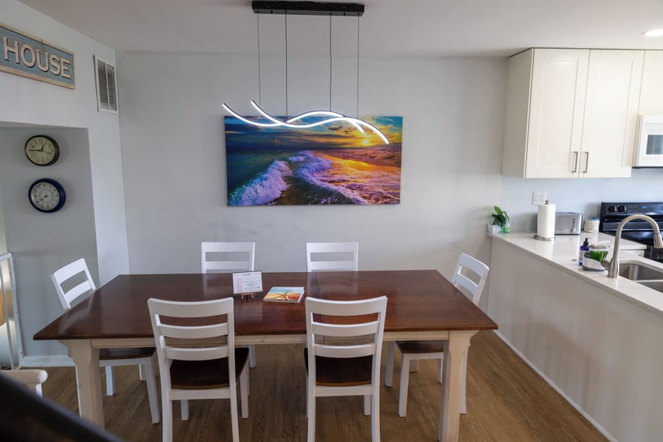 The dining area comfortable seating for up to 6 guests, offering a warm and inviting ambiance for meals and gathering.