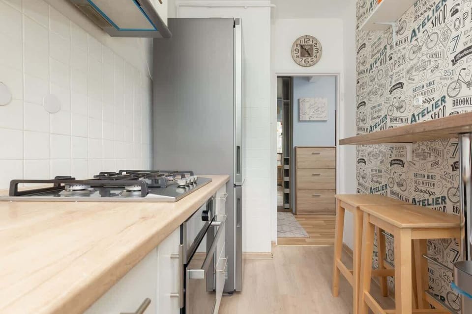The kitchen has a space for a quick breakfast with two bar stools, a large fridge that will hold all your shopping, a stove and an oven.