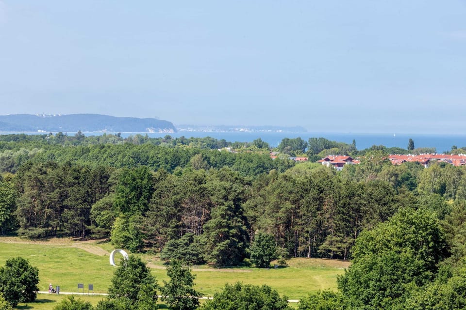 Surrounding green areas, which the guests can see from the balcony with garden furniture.