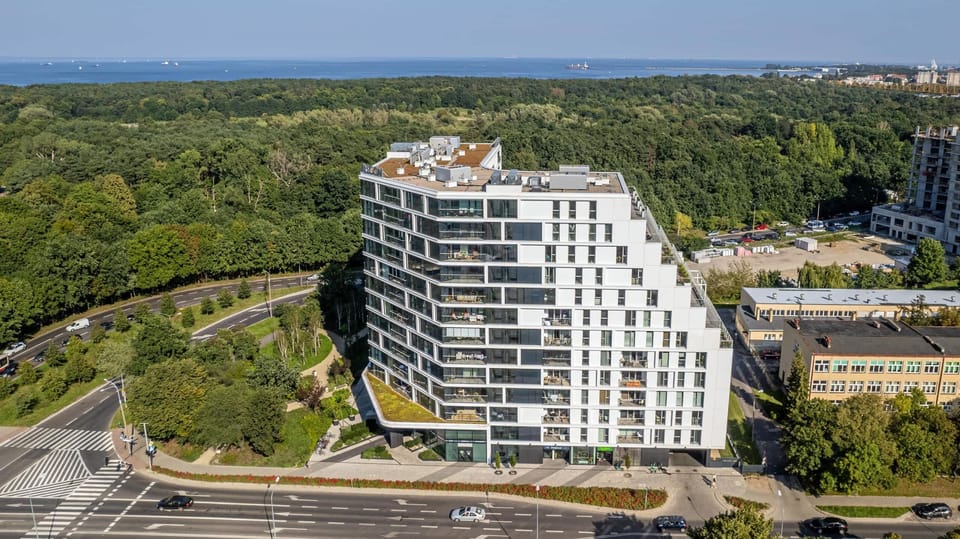Modern and elegant property building surrounded by green areas.