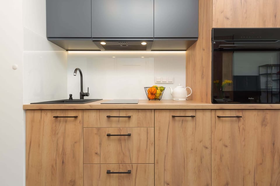 The kitchen is bright and matches the rest of the room, creating a harmonious whole full of style and elegance.