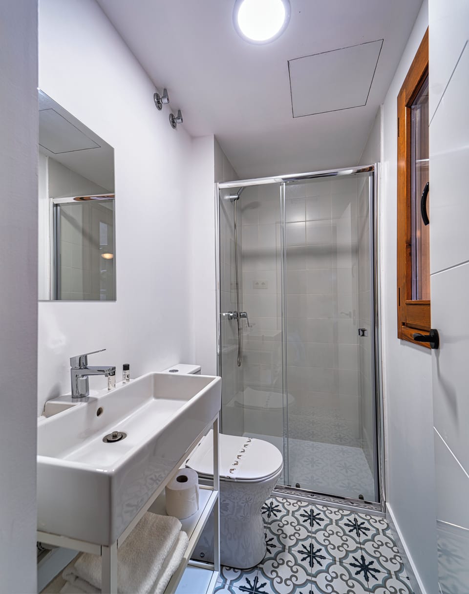 Shower, hair dryer, slippers, towels