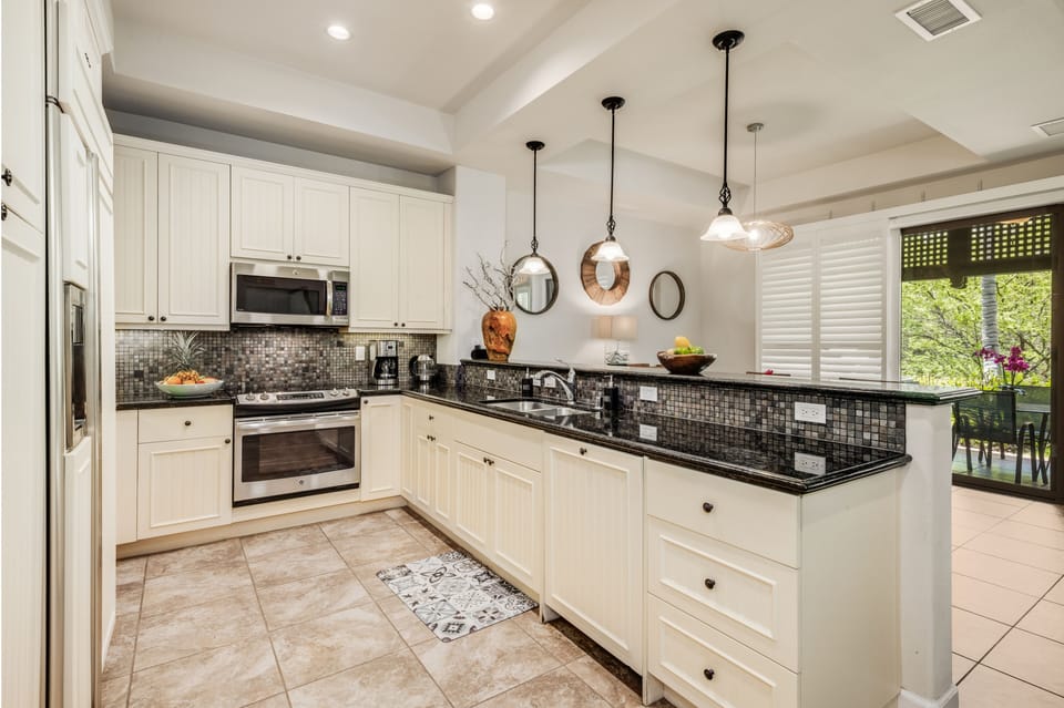 The gourmet kitchen comes with stainless steel appliances to make any chef feel right at home and is detailed with intricate tile work and cabinetry for a stylish atmosphere while preparing meals