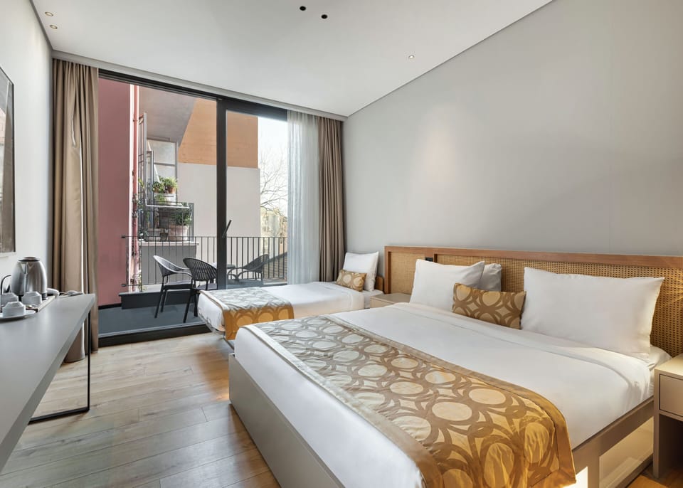 Triple Deluxe With Balcony | In-room safe, desk, laptop workspace, blackout drapes