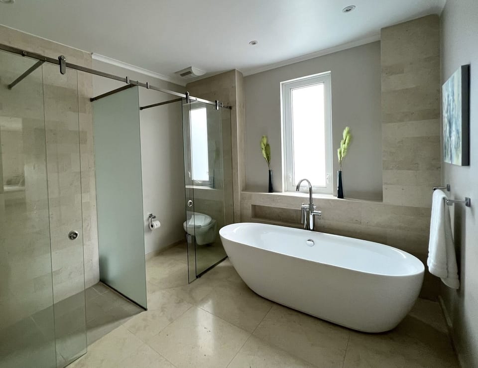 Full en-suite with a stand alone tub and  separate toilet / shower enclosures. 