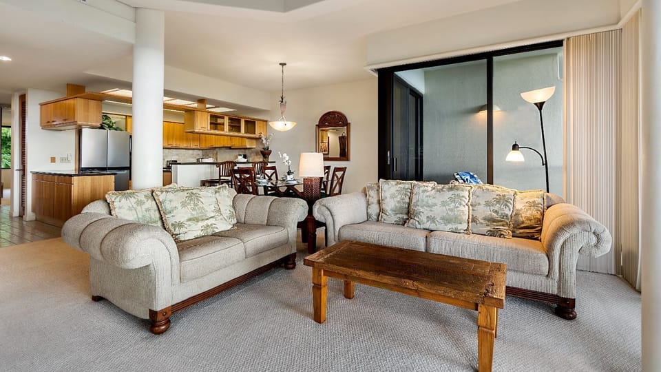 Moderately priced with original decor, this property offers an expansive living area that includes vaulted ceilings