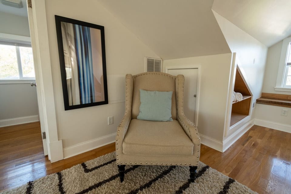 Upper-floor master bedroom with a queen bed, ensuite bathroom, Roku TV, spacious walk-in closet, and an inviting atmosphere.