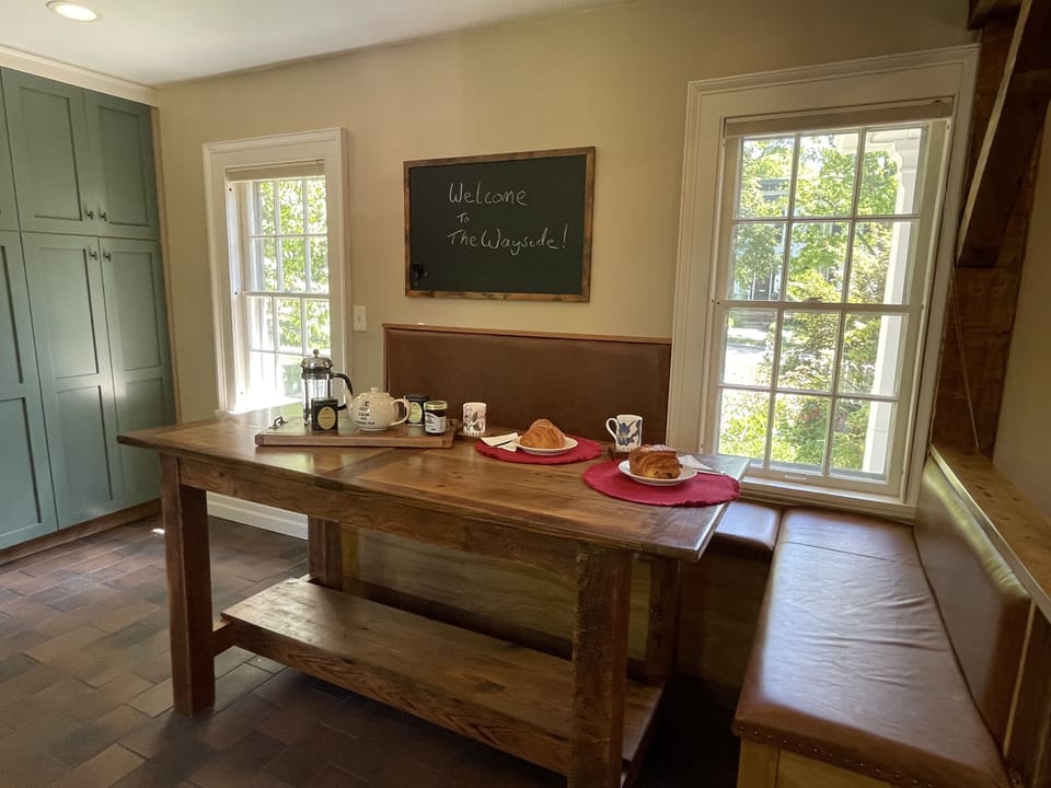 Eat-in kitchen with large farmhouse style table and bench seating
