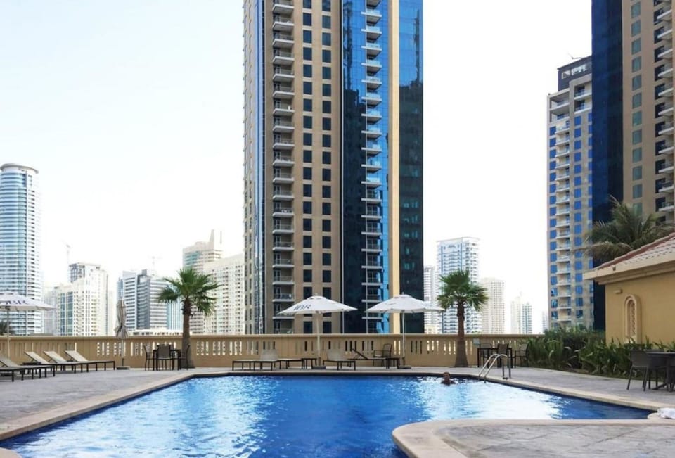Outdoor pool, pool umbrellas, sun loungers