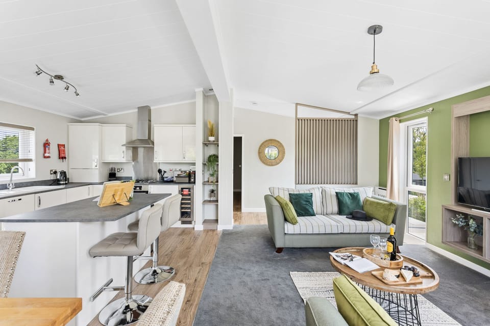 Open plan living area with access to kitchen and dining areas - Rose Lodge