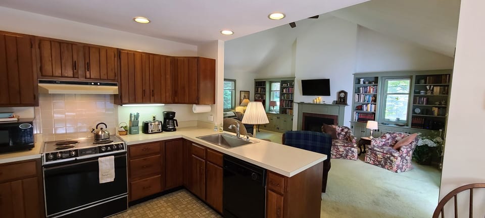 Watch the TV and gas fireplace from the kitchen while visiting with family