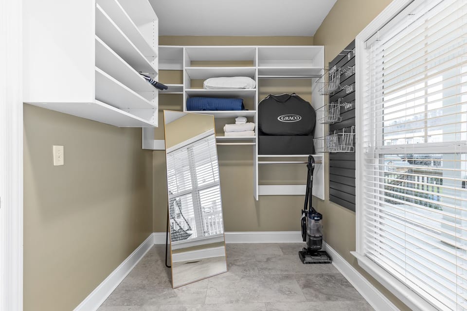 Huge master closet that houses our ironing board, iron and extra blankets 