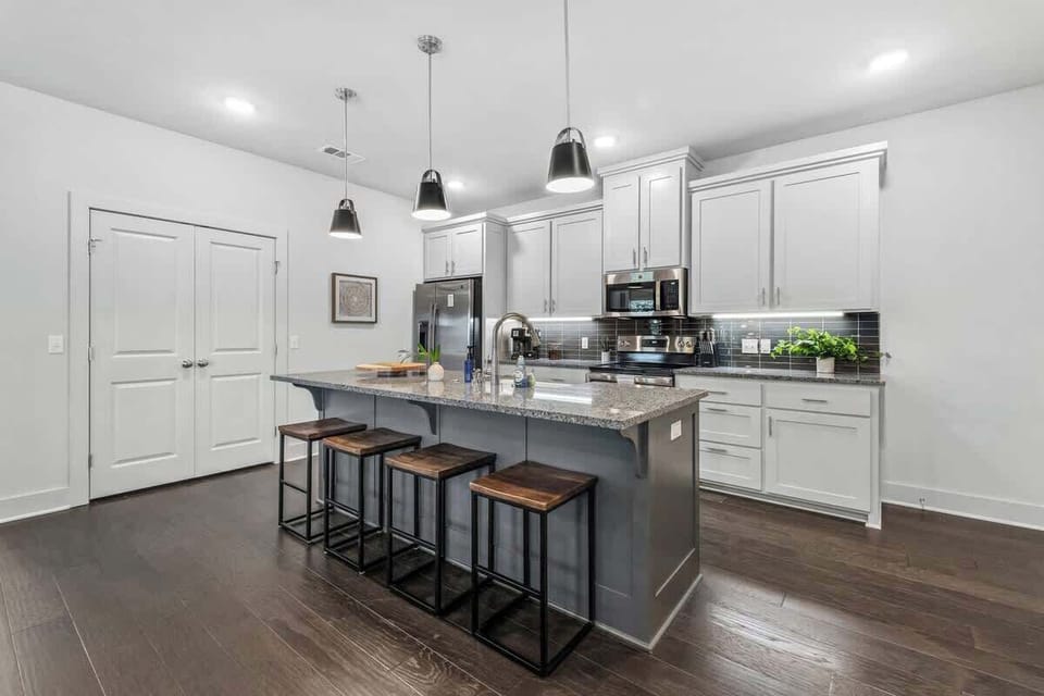 To the right, you'll see our open-concept kitchen, which is fully stocked with everything you need to cook your favorite meals.